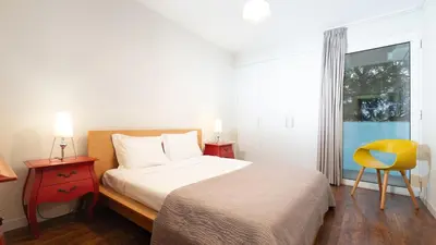 a bedroom with a bed and a yellow chair at Gardenia Apartment by LovelyStay in Funchal