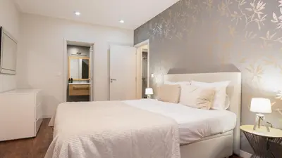 a bedroom with a white bed and a blue wall at Gardenia Apartment by LovelyStay in Funchal