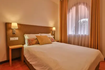 a bedroom with a white bed and a window at Theresia's in Porto Santo