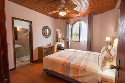 a bedroom with a bed and a bathroom at Theresia's in Porto Santo