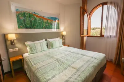 a bedroom with a bed and a window at Theresia's in Porto Santo