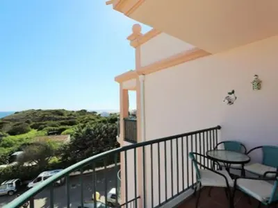 a balcony with a table and chairs and the ocean at ST JAMES in Luz