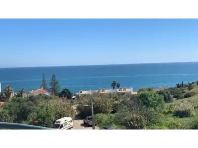 a view of a parking lot with a view of the ocean at ST JAMES in Luz