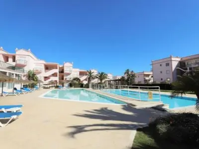a large swimming pool with chairs and buildings at ST JAMES in Luz