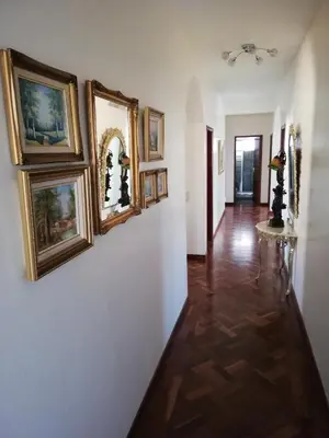 a hallway with a bunch of paintings on the wall at Atlantic house in Gaula