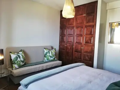 a bedroom with a bed and a wooden door at Atlantic house in Gaula