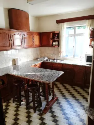a kitchen with a table with stools and a sink at Atlantic house in Gaula