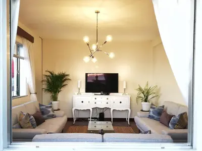 a living room with two couches and a tv at Atlantic house in Gaula