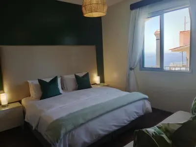 a bedroom with a large bed with a window at Atlantic house in Gaula