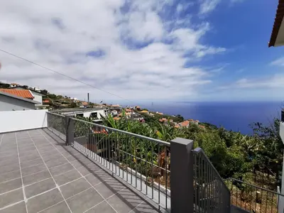 a balcony with a view of the ocean at Lucas House in Ponta do Sol