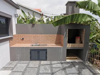 a small kitchen with a sink in a house at Lucas House in Ponta do Sol