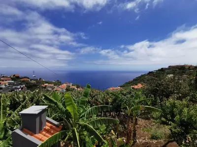 a view of the ocean from a house at Lucas House in Ponta do Sol