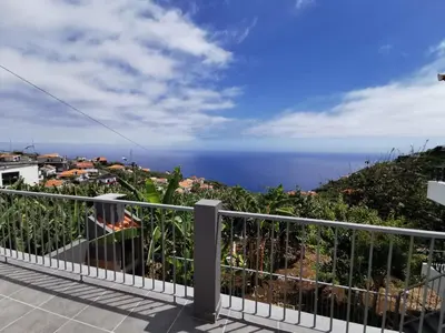 a balcony with a view of the ocean at Lucas House in Ponta do Sol