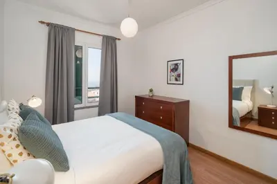 a bedroom with a bed and a mirror at Garajau III by An Island Apart in Caniço