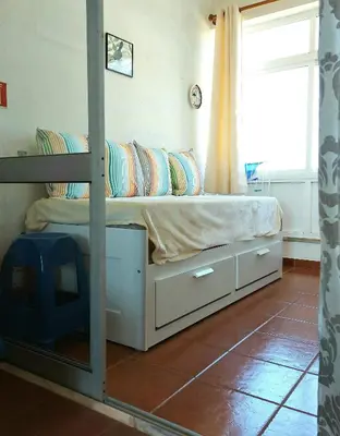a bedroom with a bunk bed with a window at Arrifana View Flat - 2km Praia Arrifana in Aljezur