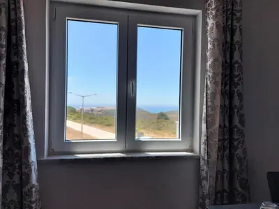 a window with a view of a road at Arrifana View Flat - 2km Praia Arrifana in Aljezur