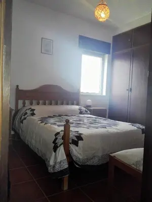 a bedroom with two beds and a window at Arrifana View Flat - 2km Praia Arrifana in Aljezur