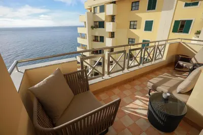 a white room with a table with a mirror at Marvelous Ocean View in Funchal