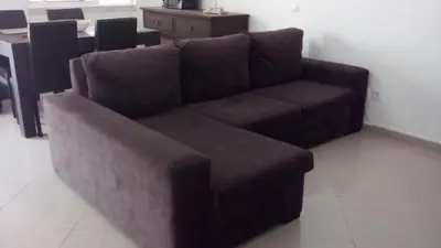 a brown couch sitting in a living room at Belinha Guest House in Luz