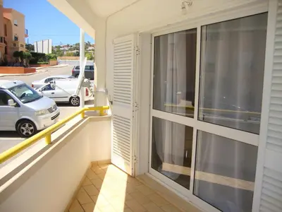 a balcony with a view of a parking lot at Belinha Guest House in Luz