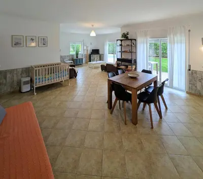 a living room with a wooden table and chairs at Apartamento Mahalo in Sagres