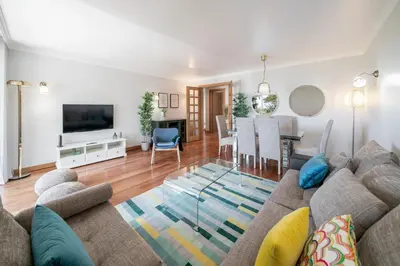 a living room with a couch and a dining room at Grand Residence I by An Island Apart in Funchal