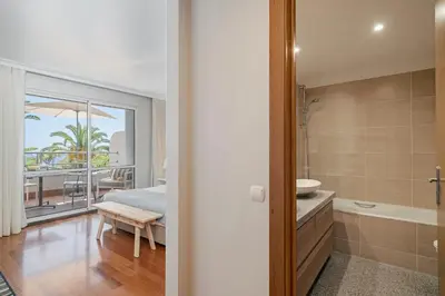 a bedroom with a bed and a bathroom with a tub at Grand Residence I by An Island Apart in Funchal