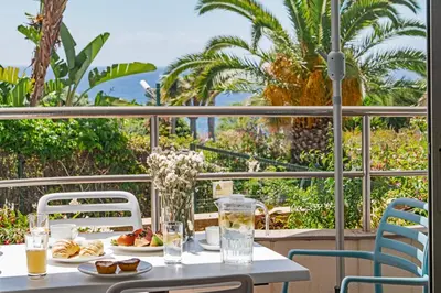 a table with food and drinks on a balcony at Grand Residence I by An Island Apart in Funchal