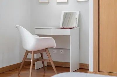 a white chair sitting in front of a desk at Grand Residence I by An Island Apart in Funchal