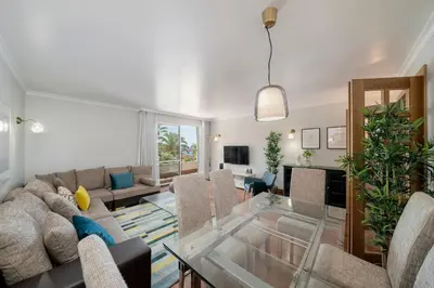 a living room with a couch and a glass table at Grand Residence I by An Island Apart in Funchal
