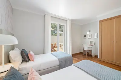 a hotel room with two beds and a table at Grand Residence I by An Island Apart in Funchal
