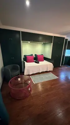 a bedroom with a bed with red pillows on it at Studio by Casa da Quinta in Funchal