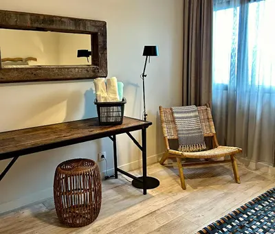 a room with a table and a mirror and a chair at Calheta Boutique Houses in Arco da Calheta