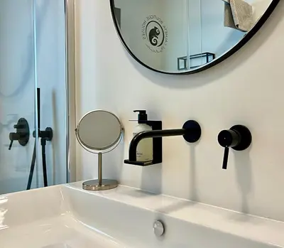 a bathroom sink with a mirror on the wall at Calheta Boutique Houses in Arco da Calheta