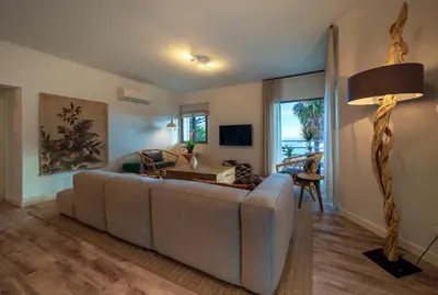a living room with a couch and a table at Calheta Boutique Houses in Arco da Calheta