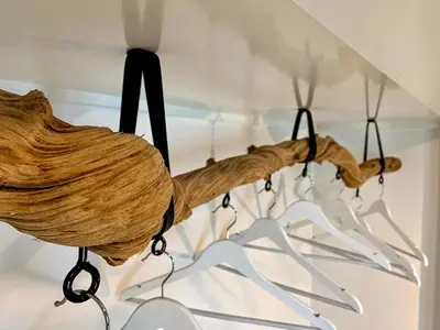 a chandelier made out of a piece of wood at Calheta Boutique Houses in Arco da Calheta