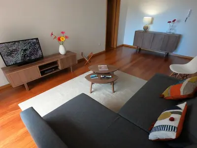 a living room with a couch and a tv at Freda House in Funchal