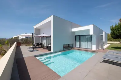 a villa with a swimming pool in front of a house at Bela Vista da Luz 17 by Destination Algarve in Luz
