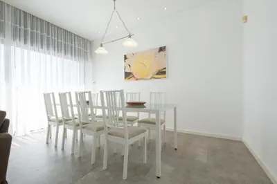 a dining room with a white table and chairs at Bela Vista da Luz 17 by Destination Algarve in Luz