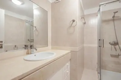 a white bathroom with a sink and a shower at Elegant Apartment with Sea Views by Trip2Portugal in Funchal