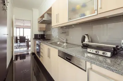 a kitchen with white cabinets and a sink at Elegant Apartment with Sea Views by Trip2Portugal in Funchal