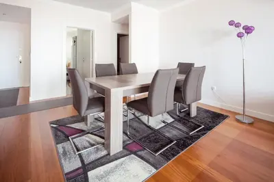 a dining room with a wooden table and chairs at Elegant Apartment with Sea Views by Trip2Portugal in Funchal