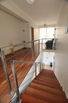 a view of a staircase in a house with wood floors at Ponte House in Porto Moniz
