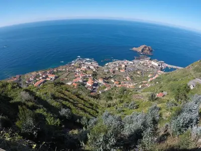 an aerial view of a village on a hill next to the ocean at Ponte House in Porto Moniz