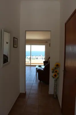 a hallway with a living room with a view of the ocean at Casa do Mar in Salema