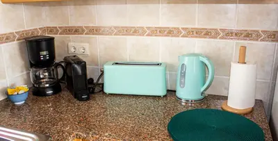 a kitchen counter with a toaster and a coffee maker at Casa do Mar in Salema
