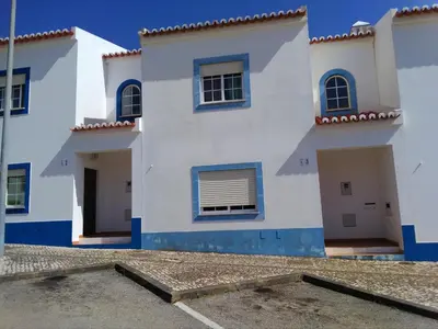 a bedroom with a bed with pillows on it at CASA DIAS in Vila do Bispo