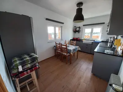 a kitchen with a table and chairs in a room at Casa Pinheirinho in Sagres