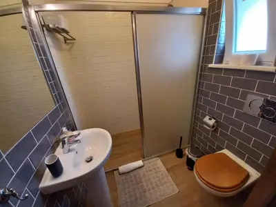 a bathroom with a shower and a sink and a toilet at Casa Pinheirinho in Sagres
