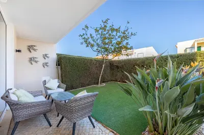 a patio with two chairs and a small lawn at Lagos Beach Pool Villa in Lagos